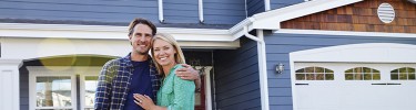 Couple in front of blue house